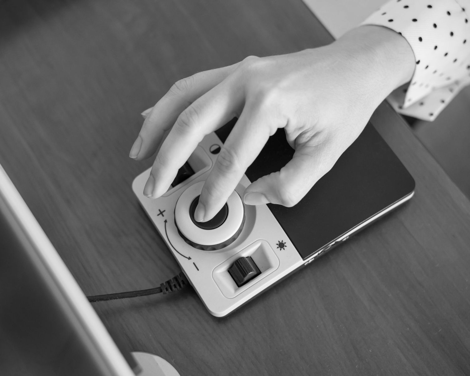 A woman uses a special magnification device for the visually impaired.