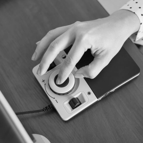 A woman uses a special magnification device for the visually impaired.